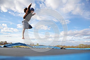 Young Child Jumping on Outdoor Family Trampoline