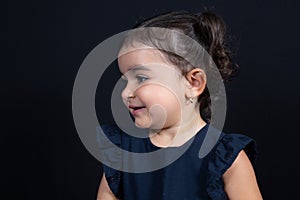 Young child kid girl look side copy space in black background