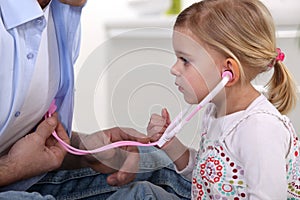 Young child listening to heartbeat