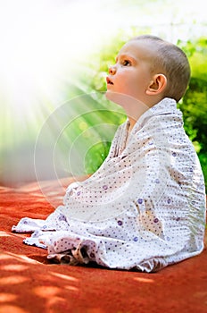 Young child looking in awe at the sun photo