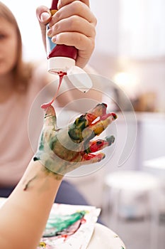 Young child playing with finger paints