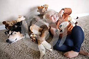 Young Child Playing with Her Pet German Shepherd Dog and Giraffe