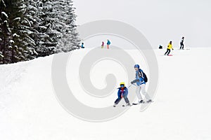 Young child, skiing on snow slope in ski resort in Austria