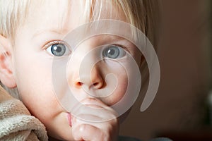 Young child sucking her thumb.