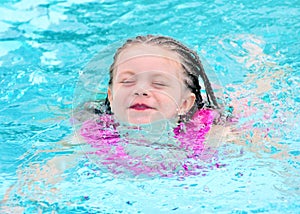 Young child swimming in pool