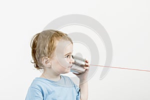 Young child with tin can phone