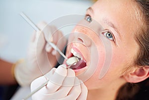 Young, child and visit dentist with teeth, mirror and mouth for medical dental hygiene consult at hospital. Girl