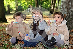 Young children blowing bubbles