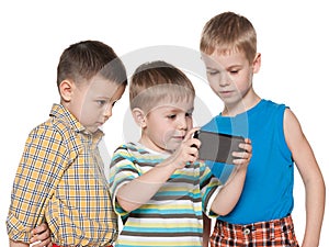 Young children plaing with a new gadget photo
