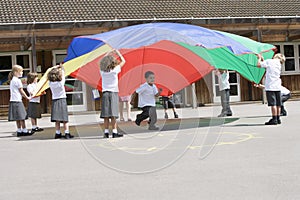 Young children playing with a parachute photo