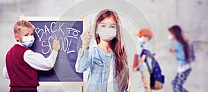 Young children with protection masks against corona virus at school