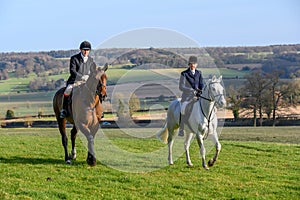 Young children sat on horses in an English countryside setting, waiting for the fox hunt to begin