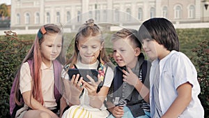 Young children using mobile phone.