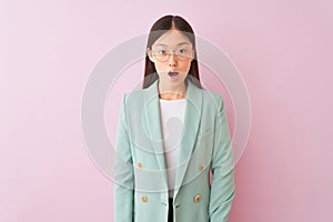 Young chinese businesswoman wearing jacket and glasses over isolated pink background afraid and shocked with surprise expression,