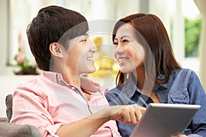 Young Chinese Couple Using Digital Tablet