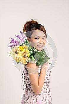 Young Chinese lady in casual attire with a bunch of flowers