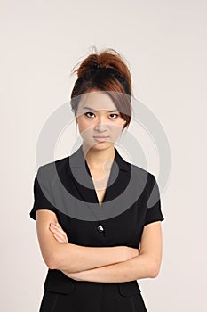 Young Chinese lady in formal attire with crossed hands