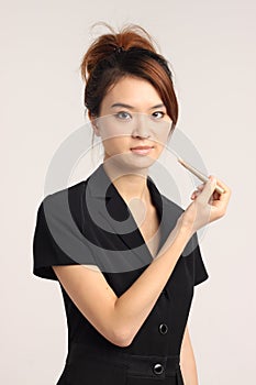 Young Chinese lady in formal attire getting ready to office