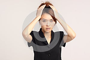 Young Chinese lady in formal attire with worried look