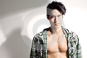 Young chinese male model baring chest, attitude