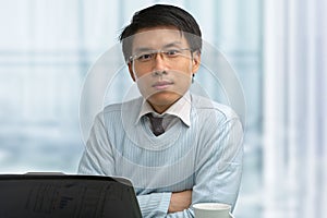 Young Chinese male working in office