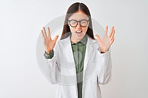 Young chinese scientist woman wearing coat and glasses over isolated white background celebrating mad and crazy for success with
