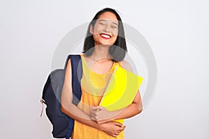 Young chinese student woman wearing backpack holding book over isolated white background with a happy face standing and smiling