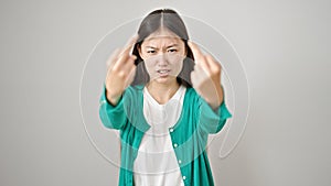 Young chinese woman doing offensive gesture with finger over isolated white background