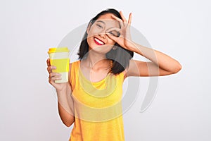 Young chinese woman drinking take away glass of coffee over isolated white background with happy face smiling doing ok sign with