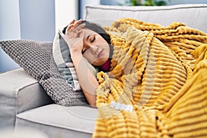 Young chinese woman ilness lying on sofa at home