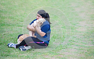 Young chinese woman outdoors holding dog