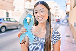 Young chinese woman smiling happy walking at street of city