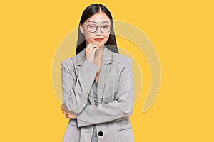 Young chinese woman wearing business clothes thinking looking tired and bored with depression problems with crossed arms