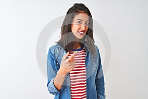 Young chinese woman wearing striped t-shirt and denim shirt over isolated white background Beckoning come here gesture with hand