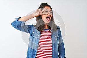 Young chinese woman wearing striped t-shirt and denim shirt over isolated white background Doing peace symbol with fingers over