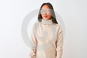 Young chinese woman wearing turtleneck sweater and glasses over isolated white background smiling looking to the side and staring