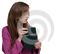Young christian woman holding the bible