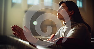 Young Christian Woman Sits Piously in Majestic Church, with Folded Hands She Seeks Guidance From