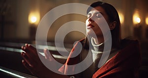 Young Christian Woman Sits Piously in Majestic Church, with Folded Hands She Seeks Guidance From