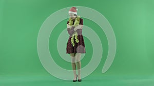 A young Christmas girl is feeling cold on the green screen