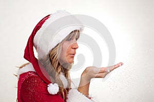 Young Christmas Woman is blowing snow