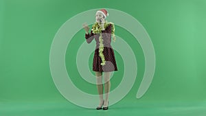 A young Christmas woman talking on her phone on the green screen