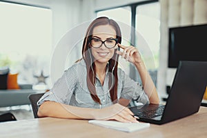 Young clever diligent woman toothy smile at laptop