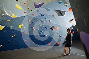 Young climber powdering hands before doing bouldering