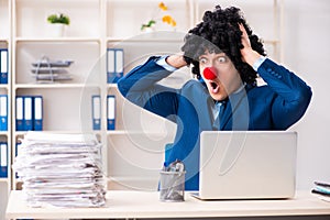 The young clown businessman working in the office
