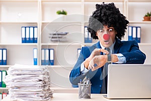 Young clown businessman working in the office