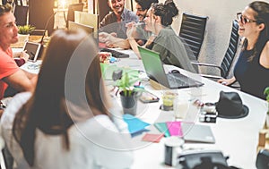 Young co-workers team talking during startup - Happy people planning a new project in creative workplace office - Focus on right photo