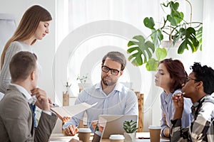 Young coach woman presenting report to colleagues in office