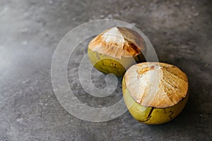The young coconut is tasty for drinking juice on stone background