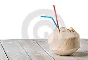 Young coconut on wooden table isolated on white